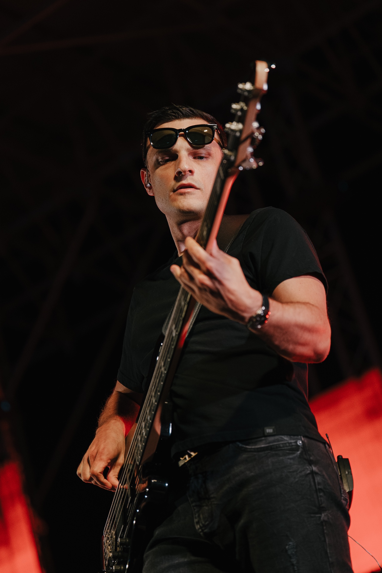 ANAEVE bassist in sunglasses with red backlight