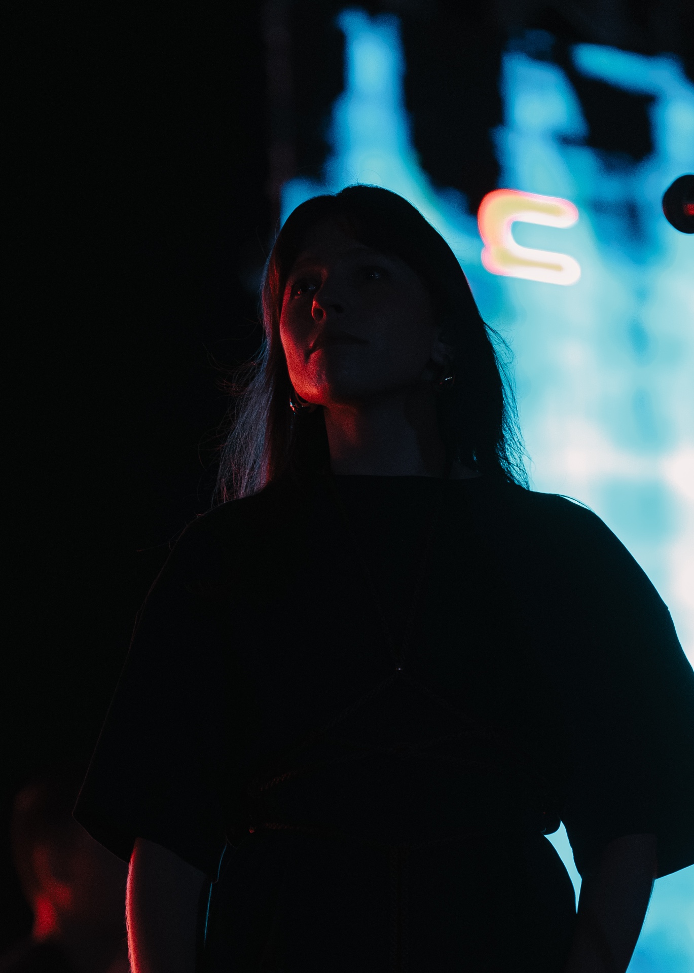 ANAEVE vocalist silhouetted against blue stage screens